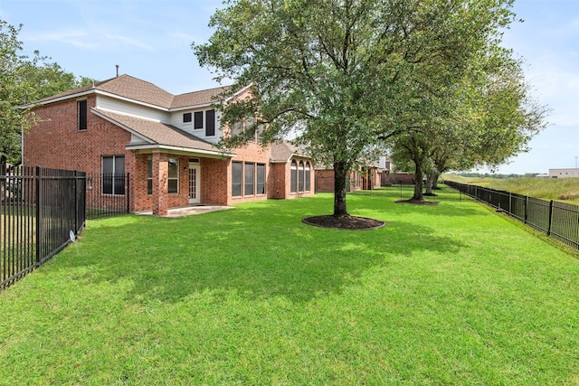 view of yard with a fenced backyard and a patio area