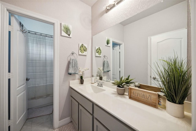 bathroom with tile patterned floors, curtained shower, and vanity
