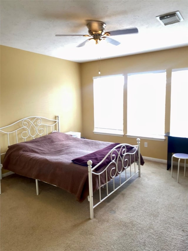 2106 Cherry Hills Dr, League City, TX 77573 - carpeted bedroom with baseboards, visible vents, a ceiling fan, and multiple windows