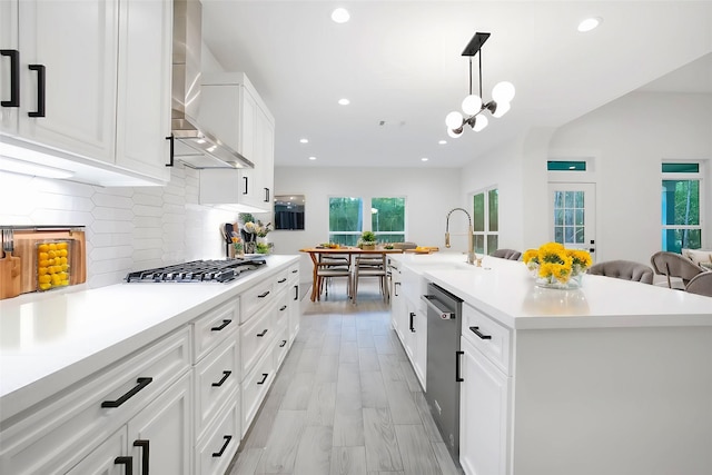 17522 Julianne Dr, Waller, TX 77484 - kitchen with light countertops, stainless steel appliances, recessed lighting, and wall chimney exhaust hood