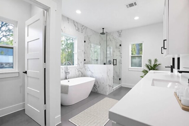 17522 Julianne Dr, Waller, TX 77484 - bathroom featuring a marble finish shower, visible vents, a freestanding tub, and a healthy amount of sunlight