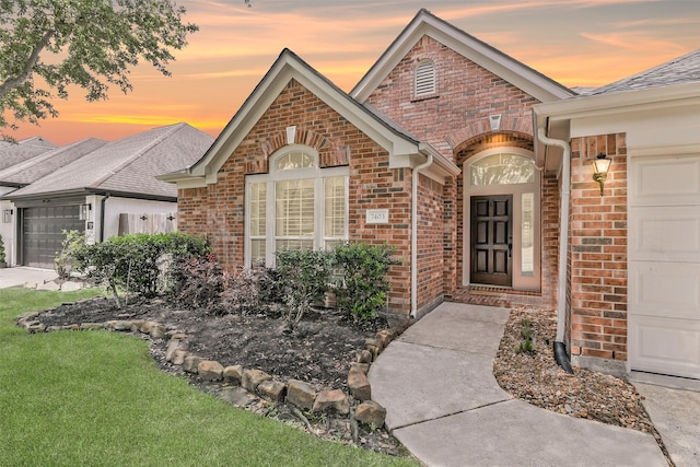 7403 Hickory Canyon Ct, Humble, TX 77396 - view of front of property with a yard, an attached garage, and brick siding
