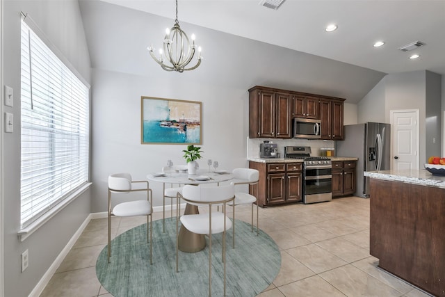 7403 Hickory Canyon Ct, Humble, TX 77396 - kitchen with appliances with stainless steel finishes, a chandelier, visible vents, dark brown cabinets, and vaulted ceiling