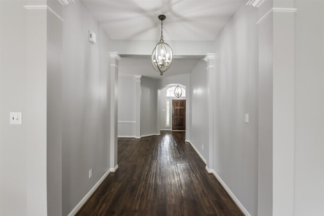 7403 Hickory Canyon Ct, Humble, TX 77396 - corridor featuring a chandelier, dark wood-style floors, and baseboards