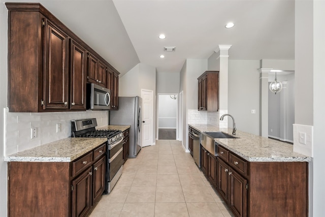 7403 Hickory Canyon Ct, Humble, TX 77396 - kitchen featuring a sink, decorative backsplash, stainless steel appliances, light tile patterned flooring, and visible vents