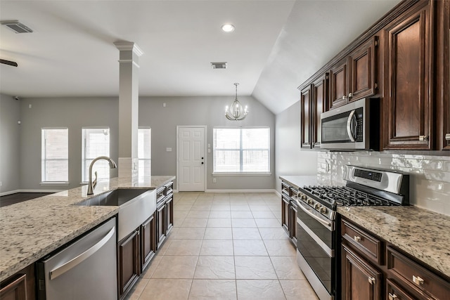 7403 Hickory Canyon Ct, Humble, TX 77396 - kitchen with appliances with stainless steel finishes, visible vents, lofted ceiling, and a sink
