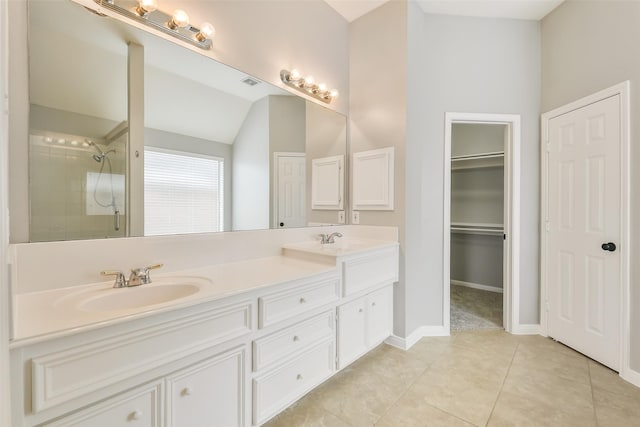 7403 Hickory Canyon Ct, Humble, TX 77396 - full bath with a sink, a tile shower, double vanity, vaulted ceiling, and tile patterned flooring
