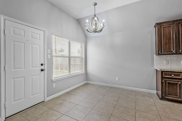 7403 Hickory Canyon Ct, Humble, TX 77396 - unfurnished dining area with light tile patterned floors, an inviting chandelier, lofted ceiling, and baseboards