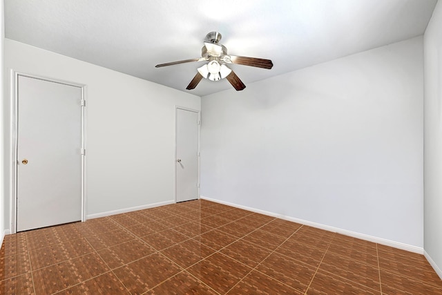 empty room with baseboards and ceiling fan