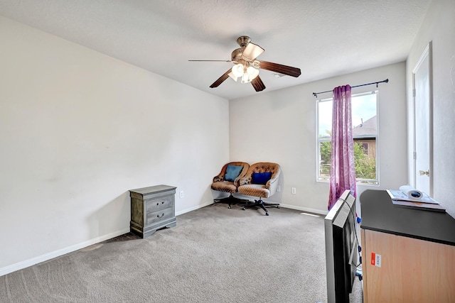 living area with ceiling fan, carpet flooring, and baseboards