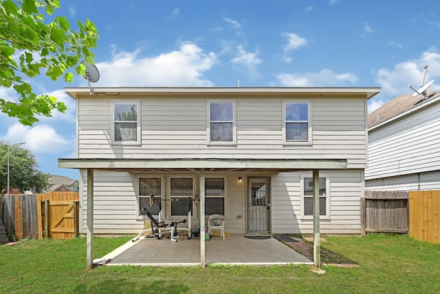 rear view of property with a gate, a patio area, a yard, and a fenced backyard