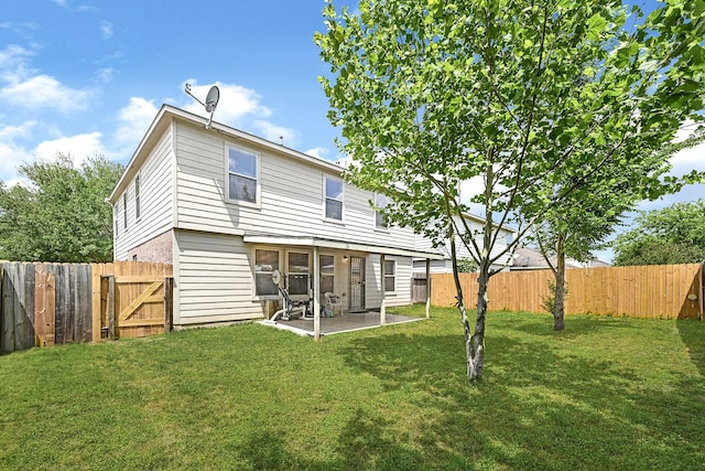 back of property featuring a lawn, a gate, a patio, and a fenced backyard