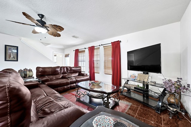 tiled living room featuring a textured ceiling and a ceiling fan
