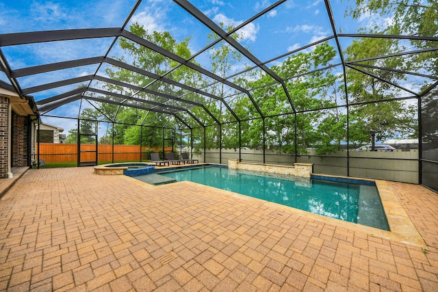 view of pool with a patio, a pool with connected hot tub, a lanai, and a fenced backyard