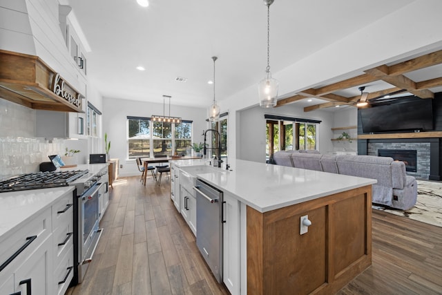kitchen with recessed lighting, stainless steel appliances, dark wood-style flooring, a sink, and white cabinetry