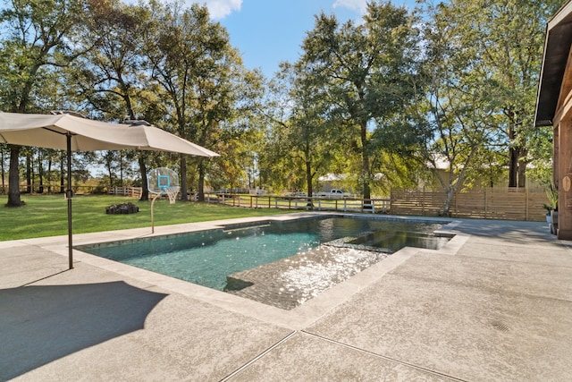 pool with a fenced backyard, a yard, and a patio area