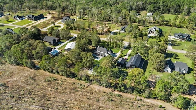 bird's eye view featuring a view of trees and a residential view