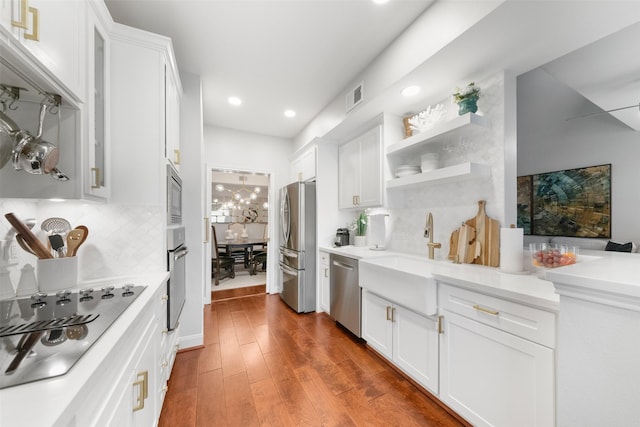 452 Mariners Dr, Kemah, TX 77565 - kitchen with white cabinetry, stainless steel appliances, wood finished floors, and a sink