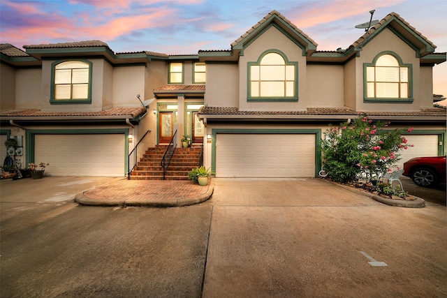 452 Mariners Dr, Kemah, TX 77565 - townhome / multi-family property featuring a tiled roof, stucco siding, concrete driveway, and an attached garage