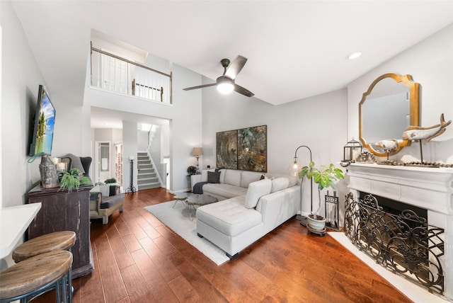 452 Mariners Dr, Kemah, TX 77565 - living room featuring recessed lighting, a fireplace, a ceiling fan, stairs, and wood finished floors