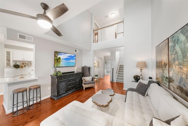 452 Mariners Dr, Kemah, TX 77565 - living room featuring wood finished floors, visible vents, ceiling fan, and stairs