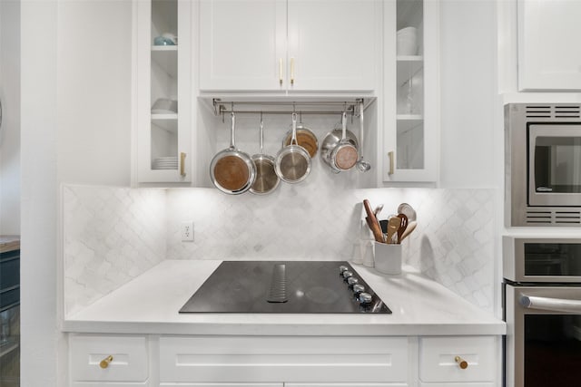 452 Mariners Dr, Kemah, TX 77565 - kitchen with appliances with stainless steel finishes, white cabinetry, and glass insert cabinets