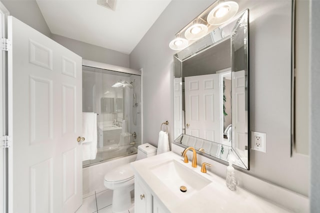452 Mariners Dr, Kemah, TX 77565 - full bath with tile patterned floors, toilet, vanity, visible vents, and bath / shower combo with glass door