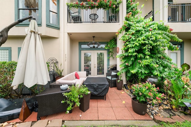 452 Mariners Dr, Kemah, TX 77565 - property entrance featuring a patio area, a balcony, an outdoor hangout area, stucco siding, and french doors