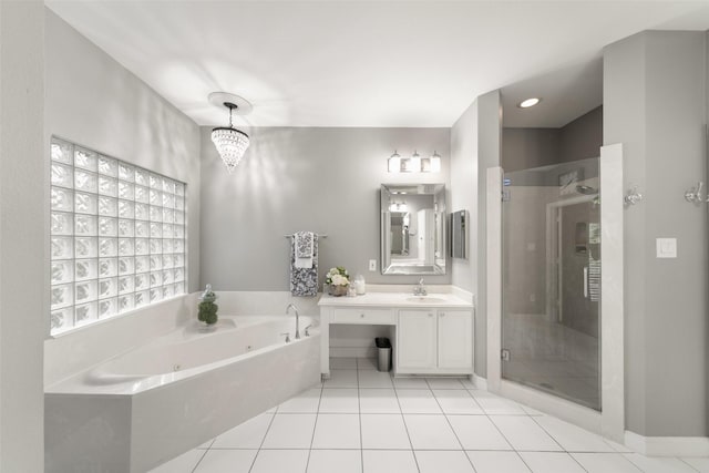 452 Mariners Dr, Kemah, TX 77565 - full bath featuring a shower stall, vanity, a chandelier, a whirlpool tub, and tile patterned flooring