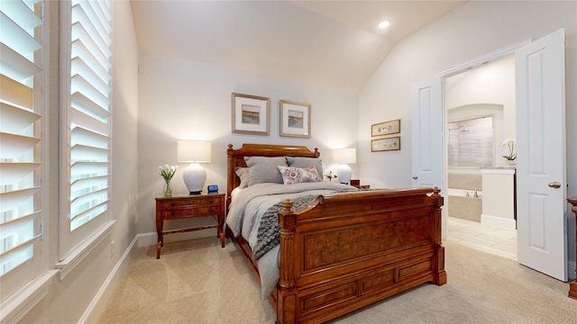 bedroom featuring light carpet, ensuite bathroom, baseboards, recessed lighting, and vaulted ceiling