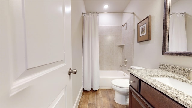 full bath featuring vanity, wood finished floors, toilet, recessed lighting, and shower / bath combo