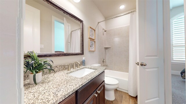 full bathroom featuring vanity, shower / tub combo with curtain, and toilet