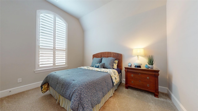 bedroom featuring baseboards, light carpet, and multiple windows