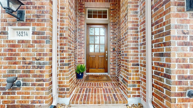 property entrance with brick siding