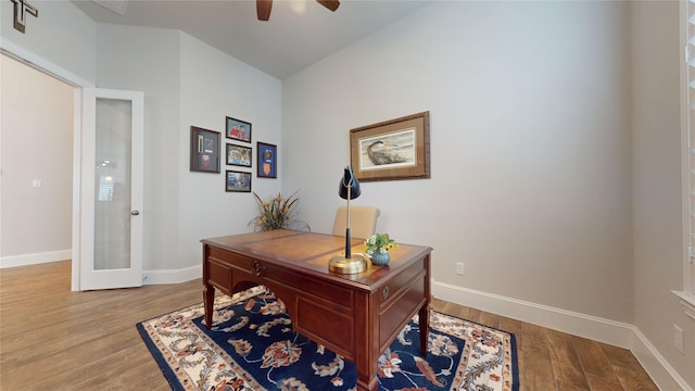 office area with french doors, a ceiling fan, baseboards, and wood finished floors