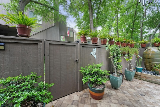 view of outbuilding featuring fence and a gate