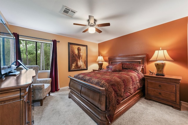 bedroom featuring baseboards, ceiling fan, light carpet, and visible vents