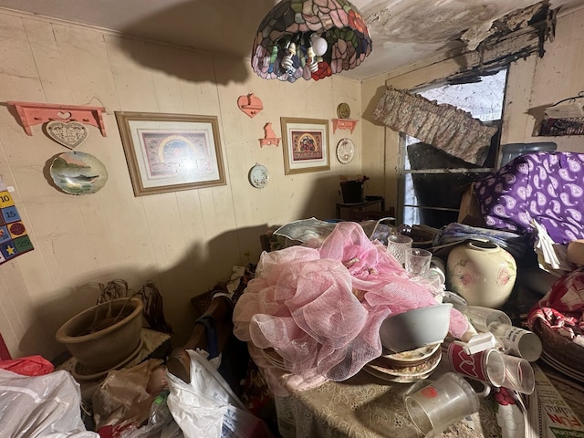 miscellaneous room featuring wood walls