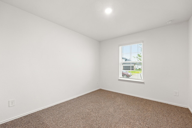 carpeted spare room featuring baseboards and recessed lighting
