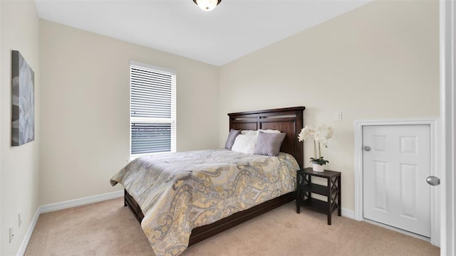 bedroom featuring baseboards and light carpet