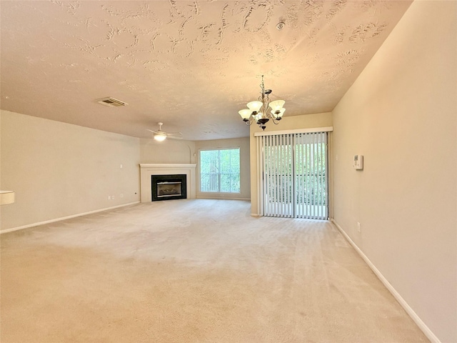 8051 Bay Branch Dr Unit 424, The Woodlands, TX 77382 - unfurnished living room featuring a textured ceiling, baseboards, visible vents, and carpet