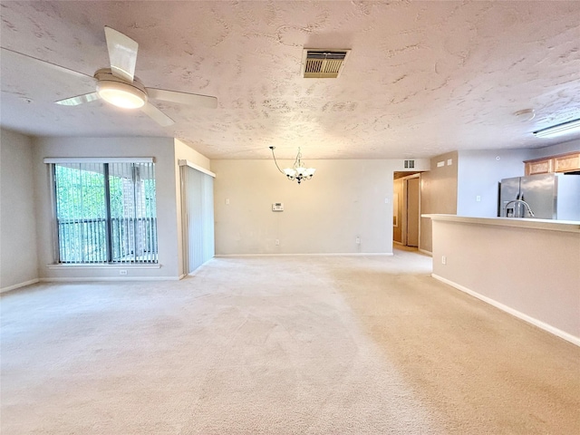 8051 Bay Branch Dr Unit 424, The Woodlands, TX 77382 - unfurnished living room with visible vents, baseboards, and ceiling fan with notable chandelier