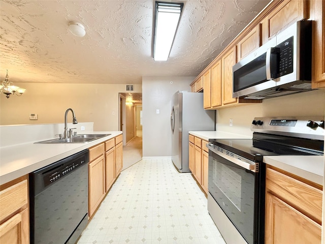 kitchen featuring light brown cabinetry, a sink, light countertops, stainless steel appliances, and light floors