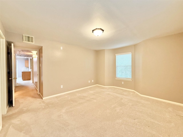 8051 Bay Branch Dr Unit 424, The Woodlands, TX 77382 - spare room with baseboards, light colored carpet, and visible vents