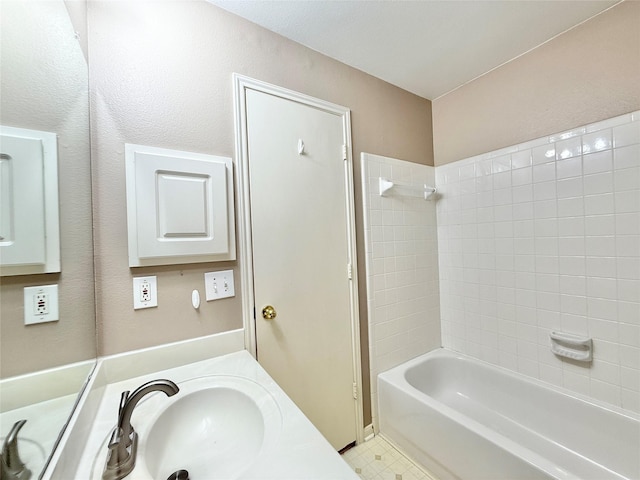 bathroom featuring a sink and shower / tub combination