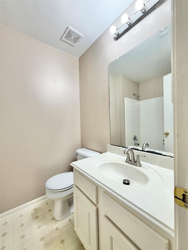 8051 Bay Branch Dr Unit 424, The Woodlands, TX 77382 - bathroom with visible vents, walk in shower, vanity, baseboards, and toilet