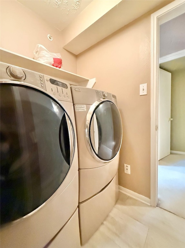 8051 Bay Branch Dr Unit 424, The Woodlands, TX 77382 - clothes washing area with laundry area, baseboards, and washer and dryer
