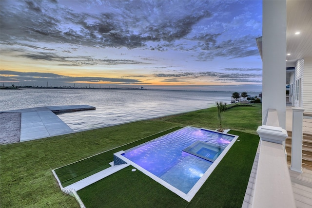 view of pool featuring a water view and an in ground hot tub