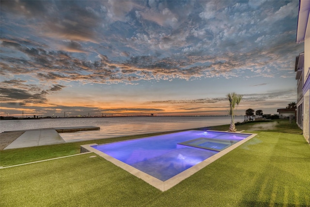 view of swimming pool with a yard and a jacuzzi