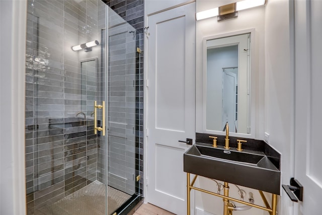 full bathroom with a sink and a shower stall